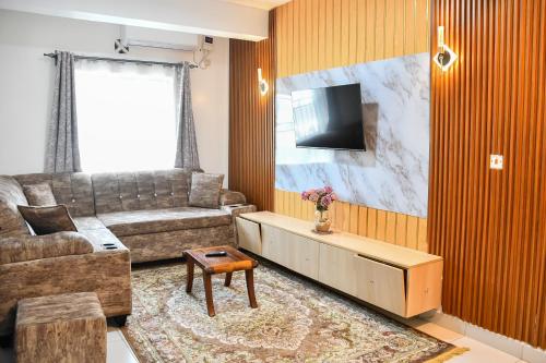 a living room with a couch and a tv at Buxton Point Mombasa in Mombasa