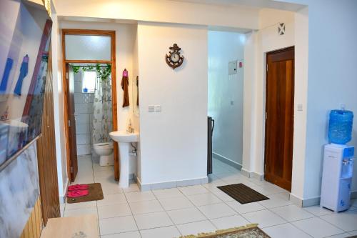 a bathroom with a toilet and a sink at Buxton Point Mombasa in Mombasa