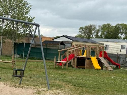 a playground with several slides and a play structure at Dunepark in Nieuwpoort