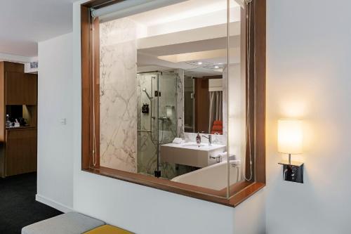 a bathroom with a sink and a mirror at United Hotel in Taipei