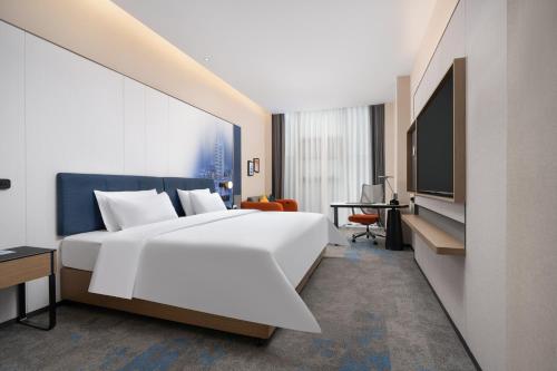 Ένα ή περισσότερα κρεβάτια σε δωμάτιο στο Hilton Garden Inn Zhengzhou Xinzheng International Airport