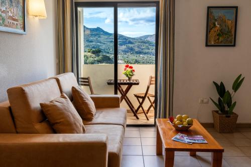 a living room with a couch and a table at APARTAMENTOS SERRELLA - Rural Guadalest in Benimantell