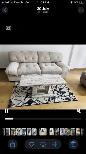 a living room with a couch and a coffee table at Shalom Apartment in Lusaka