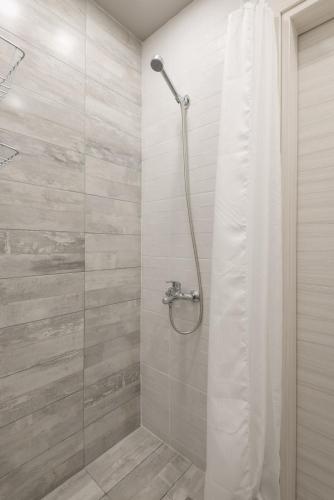a shower with a shower curtain in a bathroom at Peraia beachfront apartment in Perea