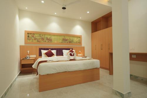 a bedroom with a large bed in a room at Winspark Inn Resort in Varkala