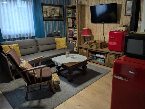a living room with a couch and a coffee table at Altes Häusle am Waschbach-Weinstock in Edenkoben
