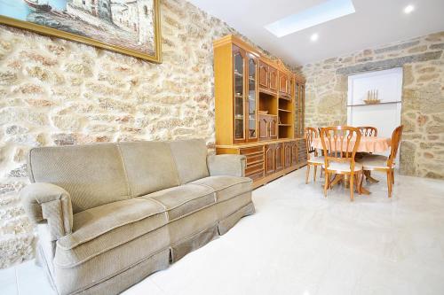 a living room with a couch and a table at Adosados en Vilanova de Arousa in Villanueva de Arosa