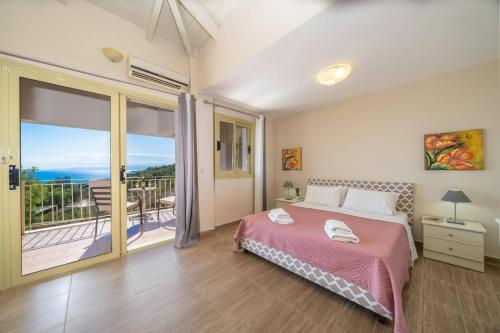 a bedroom with a bed and a balcony at Villa Apollon by Villa Plus in Spathíon