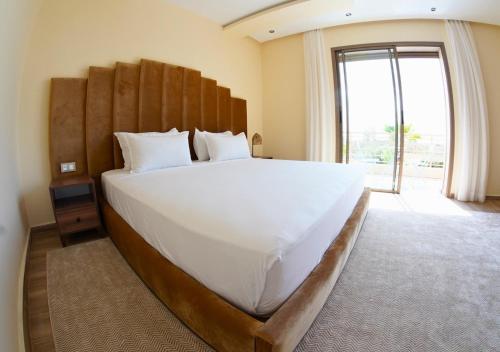 a bedroom with a large bed with a large window at Villa with Private Pool in Marrakech - Dar Mazar in Oubadine