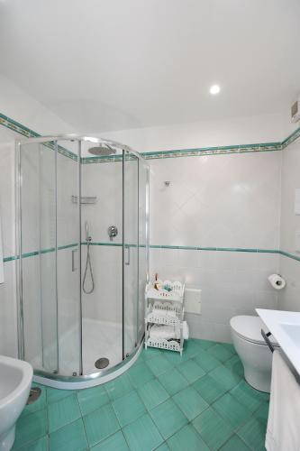a bathroom with a shower and a toilet and a sink at La Cascata in Amalfi