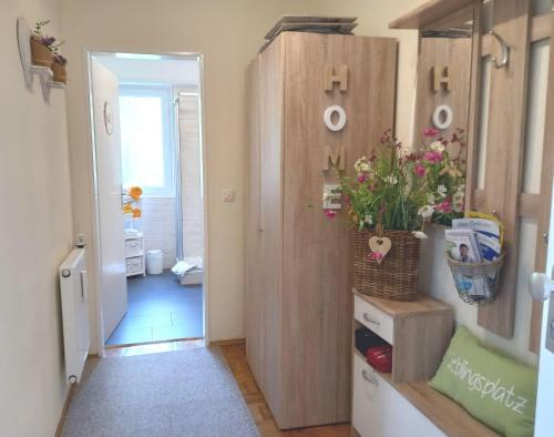 a hallway with a door and flowers in a room at Harz-Fewo-Wolf in Bad Harzburg