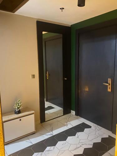 a hallway with a mirror and green walls and a floor at paradise hotel in Istanbul