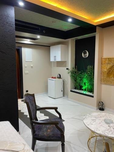 a living room with a table and chairs and a fishtank at paradise hotel in Istanbul