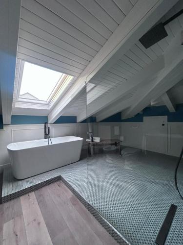 a large bathroom with a large tub and a window at Q suites urban relais in Turin