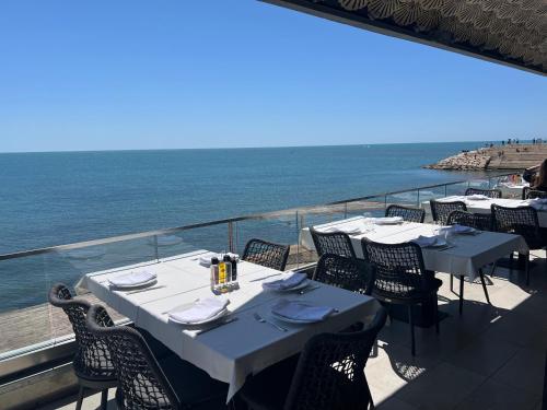 two tables and chairs on a balcony with the ocean at Sea View Apartments in Durrës