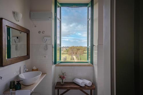 a bathroom with a sink and a window at Casale Malatesta in Velletri