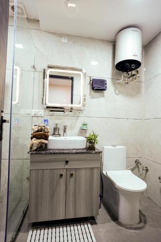 a bathroom with a sink and a toilet at Avaani Residency in Jalandhar