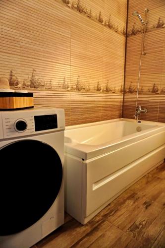 a bathroom with a bath tub and a sink at FLH - MIG Loft Sibiu in Cisnădie
