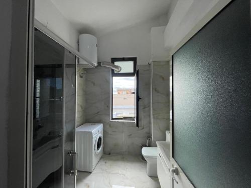 a bathroom with a shower and a toilet and a sink at I&O Loft360 in Shkodër
