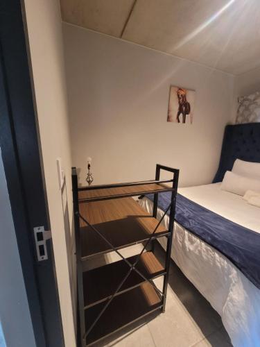 a small bedroom with a bunk bed and a ladder at Home away from home in Midrand