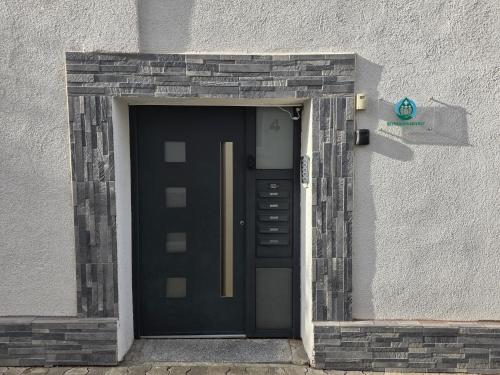 a black door in a window of a building at Moderne 2,5 Zimmer Wohnung in Herne im Herzen des Ruhrgebiets in Herne