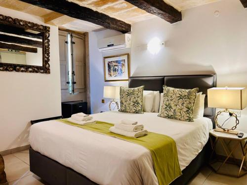 a bedroom with a large bed with towels on it at Casa Birmula Boutique Hotel in Cospicua