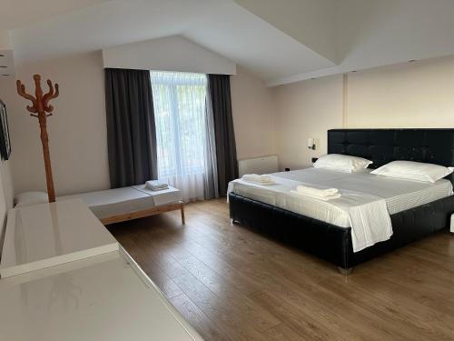 a bedroom with a large bed and a window at Jon Private Vila 