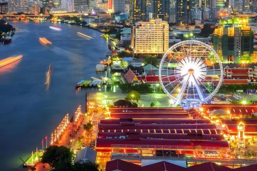 a city skyline at night with a ferris wheel at GO INN Asiatique BKK - โกอินน์ เอเชียทีค เจริญกรุง xPro in Godown
