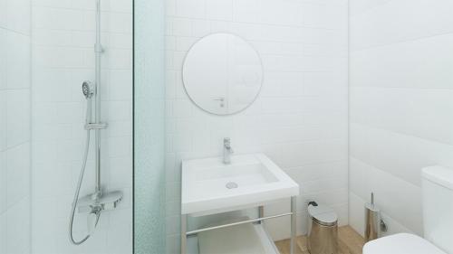 a white bathroom with a sink and a shower at Hotel Foners in Playa de Palma