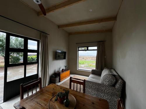 a living room with a table and a couch at Rietfontein 1888 in De Aar