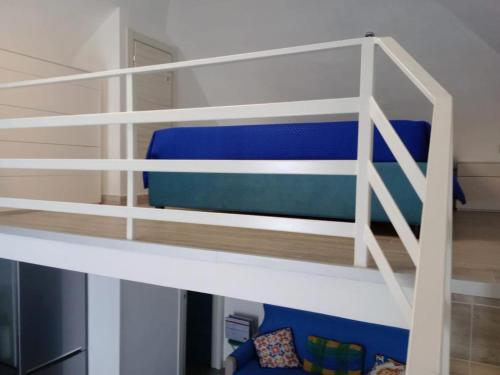 a bunk bed in a room with a blue chair at La Perla del Borgo in Vieste