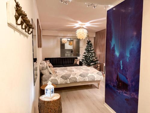 a bedroom with a christmas tree and a bed at Warm Wooden Home in Rovaniemi in Rovaniemi