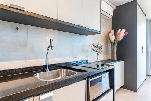 a kitchen with a sink and a counter at BHS Flat a beira mar 2203 in Recife