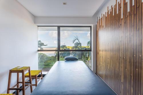 a living room with a large window and a large blue carpet at BHS Flat a beira mar 2203 in Recife