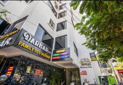 a building with a sign for a family restaurant at At Home Hotel Darbar in Hyderabad