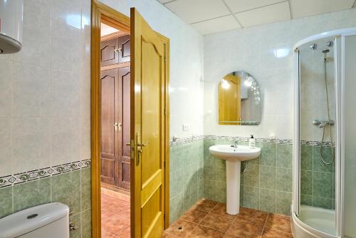 a bathroom with a sink and a toilet and a mirror at Seralva Rural Zuheros in Zuheros