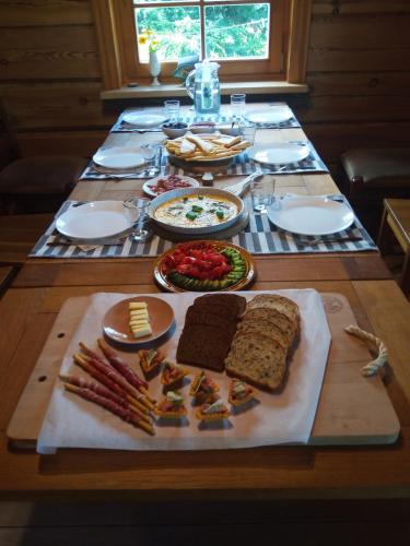 ein Tisch mit einem Teller mit Essen auf einem Tisch in der Unterkunft Stirnelės viensėdis in Stirniai