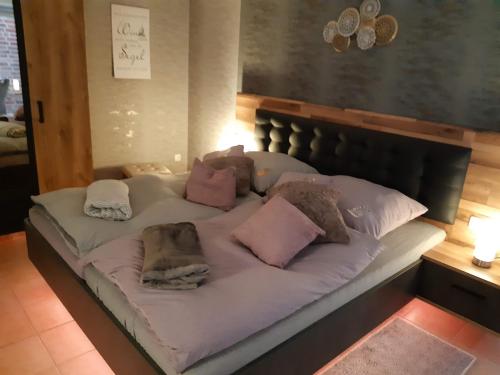 a bed with pillows on it in a room at Pension Zur Mühle in Nettetal