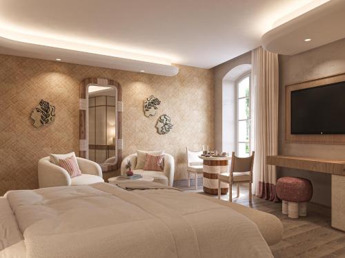una camera d'albergo con un letto e una TV a schermo piatto di Hôtel de La Fontaine a Lourmarin