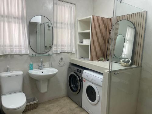 a bathroom with a washing machine and a sink at Molensicht No. 8 in Swakopmund