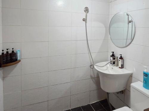 a white bathroom with a sink and a mirror at Stay jongno238 in Seoul
