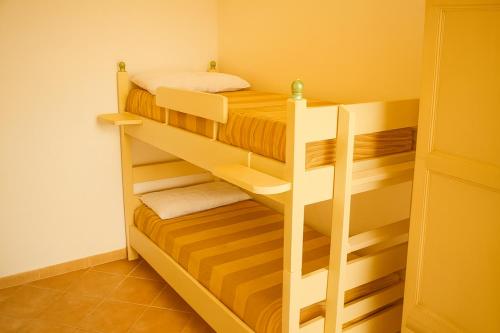 a bedroom with two bunk beds in a room at Sa Domittedda in Sassari