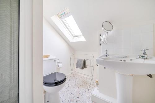 a bathroom with a toilet and a sink at Edinburgh House in Burnham Market