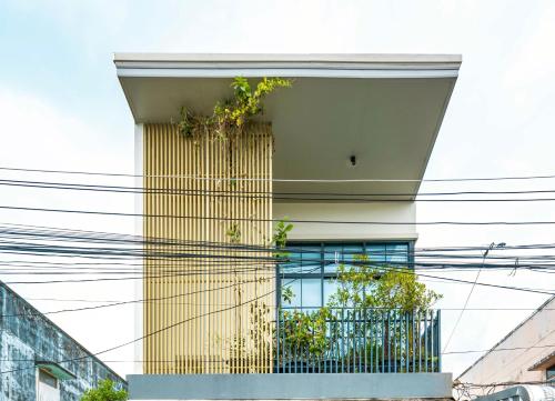 a building with plants on the side of it at Ellie House Phuket Old Town in Ban Rangeng