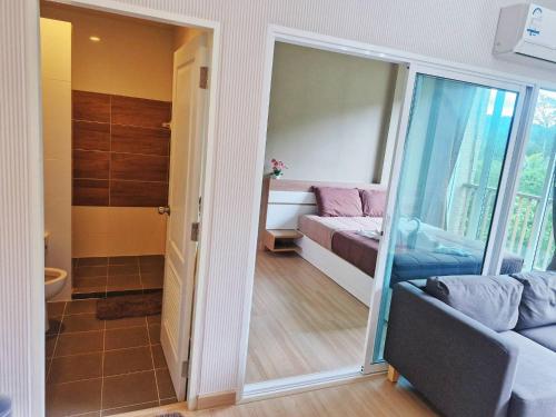 a room with a bed and a sliding glass door at Baan Khaoyai by Chateau in Ban Tha Maprang
