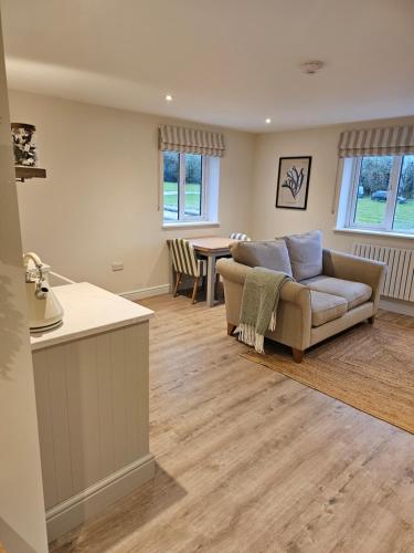 a living room with a couch and a table at Newditch Farm - BRS Airport in Bristol