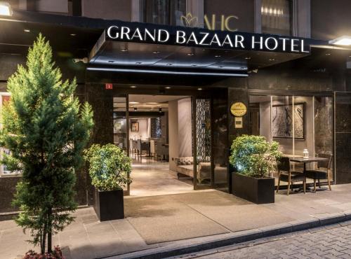 a grand bazaar hotel with two trees in front of it at AHC Grand Bazaar Hotel in Istanbul