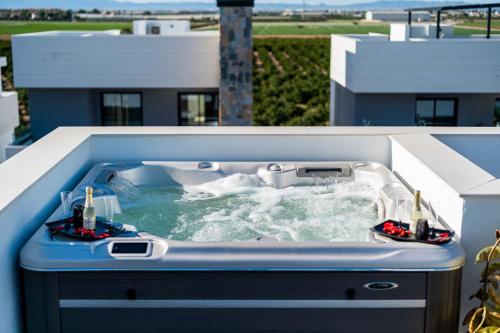 a jacuzzi tub on top of a building at Villa de lujo con jacuzzi, cine, billar y futbolín in Las Casicas