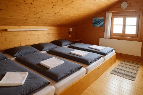 a room with four beds in a cabin at Wallackhaus hütte in Untertauern