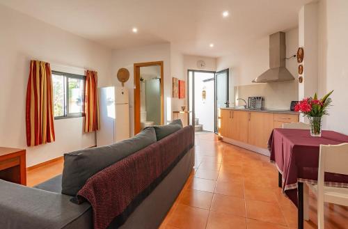 a living room with a couch and a kitchen at Terrace Villa with Sea View in Santa Luzia